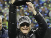 Seattle Seahawks owner Paul Allen holds up the George Halas Trophy on Jan. 19 after the NFL football NFC Championship game against the San Francisco 49ers.