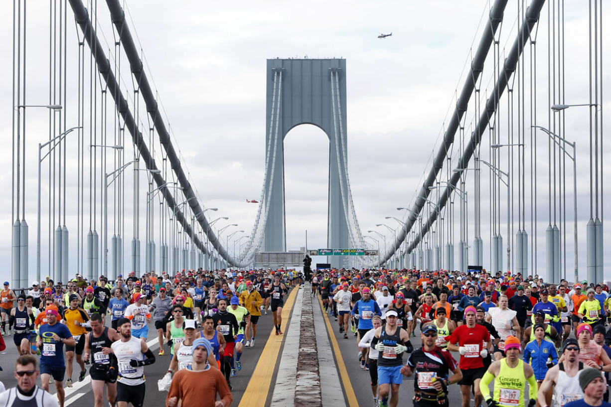 Runners cross the Verrazano-Narrows Bridge at the start of the New York City Marathon, Sunday, Nov. 3, 2013, in New York.