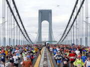 Runners cross the Verrazano-Narrows Bridge at the start of the New York City Marathon, Sunday, Nov. 3, 2013, in New York.