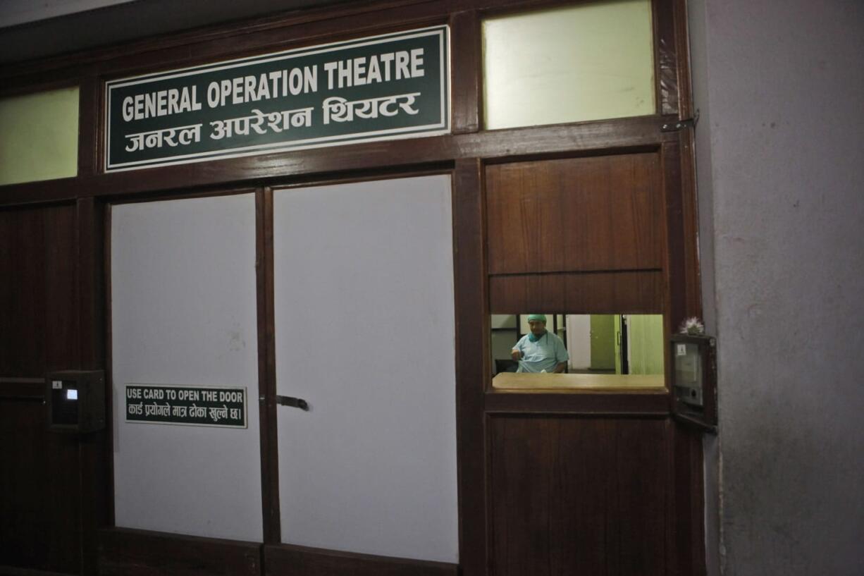 A doctor stands inside the emergency ward of Bir Hospital on Thursday in Kathmandu, Nepal. Hospitals have started to cut services, doctors said, because of medicine shortages.