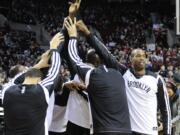 Brooklyn's Jason Collins, right, cheers with teammates before Wednesday's game against the Portland Trail Blazers at the Moda Center.