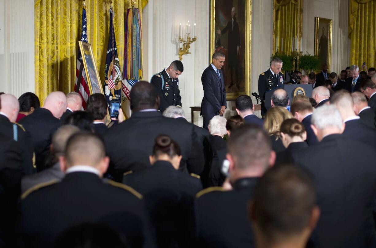 President Barack Obama and Florent Grobert bow their heads during a ceremony where the president bestowed the nation&#039;s highest military honor, the Medal of Honor to Groberg, on Thursday in the East Room of the White House in Washington. The former Army captain received the medal after he tackled a suicide bomber while serving in Afghanistan.