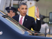 President Barack Obama motions toward media members after arriving Sunday at Seattle-Tacoma International Airport.