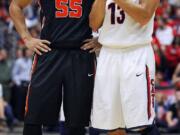 Oregon State's Roberto Nelson (55) and Arizona's Nick Johnson (13) visit during an Oregon State foul shot in the second half of an NCAA college basketball game on Sunday, Feb. 9, 2014, in Tucson, Ariz.