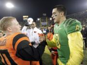 Oregon quarterback Marcus Mariota, right, shakes hands with Oregon State receiver Blair Cavanaugh after an NCAA college football game in Eugene, Ore., Friday, Nov. 29.