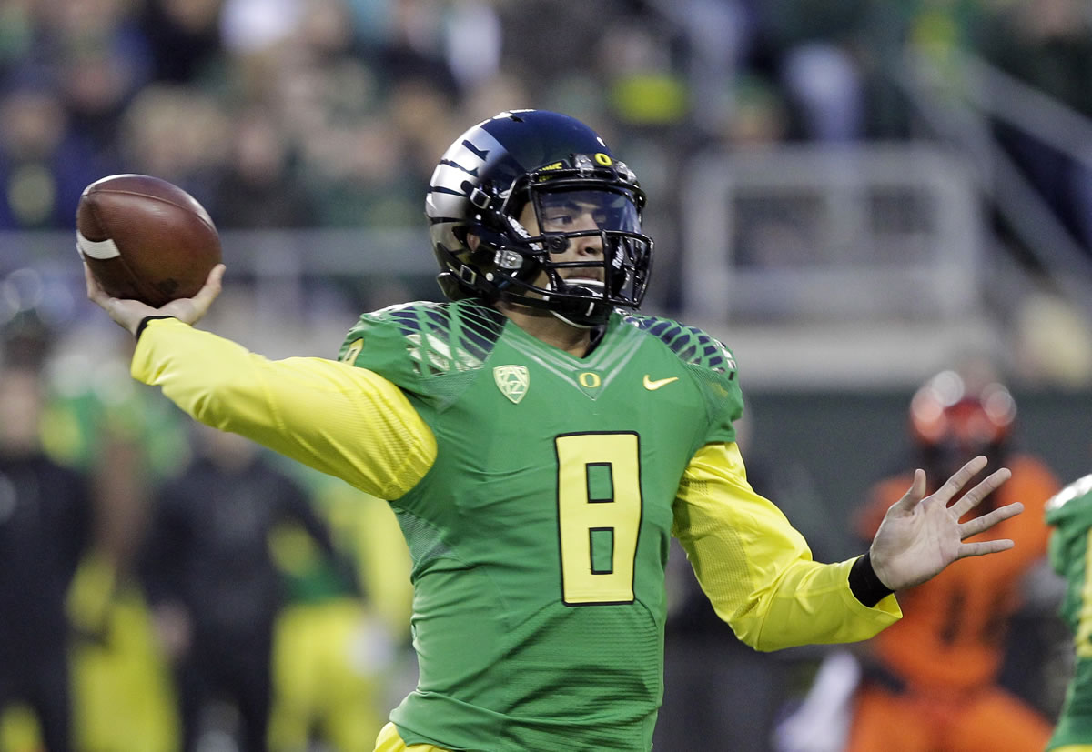 Oregon quarterback Marcus Mariota throws during the first half Friday.