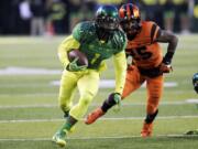 Oregon receiver Josh Huff, left, heads down the field past Oregon State defender Ryan Murphy during the first half Friday.