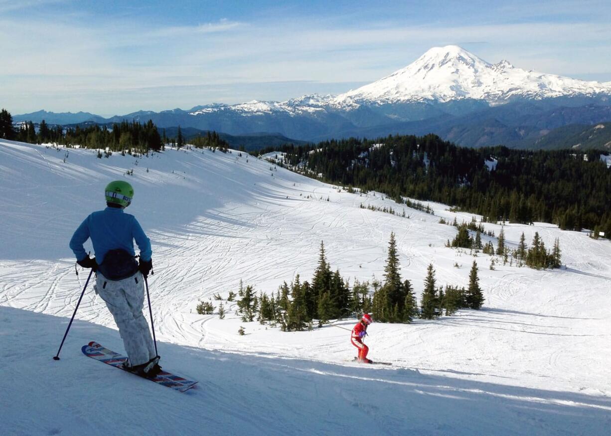 Rachel Emmons of Yakima, left, watches Nora Emmons ski the Snow Devil run, 6,500 feet above sea level, Feb. 13 at White Pass in Naches. Skiing is an expensive sport, but some industry insiders say that&#039;s not necessarily the biggest obstacle keeping skiers off the slopes. The other biggie: not having somebody to ski with you.