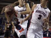 Gonzaga's Drew Barham (43) and Kyle Dranginis (3) fight for a rebound against Pacific's Khalil Kelley during the first half Saturday, Jan. 4, 2014, in Spokane, Wash.