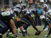 Seattle Seahawks center Patrick Lewis gets set to snap the ball on the line of scrimmage against the Carolina Panthers in the second half of an NFL football game, Sunday, Oct. 18, 2015, in Seattle.