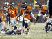 Denver Broncos running back C.J. Anderson (22) breaks free for the game-winning touchdown against the New England Patriots during overtime of an NFL football game, Sunday, Nov. 29, 2015, in Denver. The Broncos defeated the Patriots 30-24.