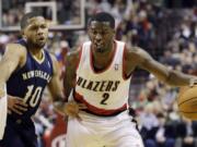 Portland Trail Blazers guard Wesley Matthews, right, drives past New Orleans Pelicans guard Eric Gordon during the first half in Portland on  Saturday.