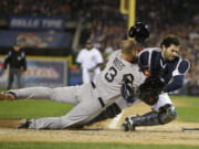 Boston Red Sox's David Ross collides with Detroit Tigers catcher Alex Avila in the second inning during Game 5 of the American League baseball championship series in Detroit.