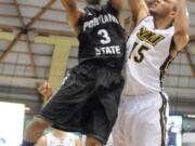 Portland State guard Andre Winston Jr. (3) tries for a shot against Northern Arizona defenders during Saturday's Big Sky Conference game at Flagstaff, Ariz.