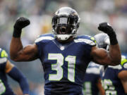 Seattle Seahawks strong safety Kam Chancellor (31) celebrates a hit on St. Louis Rams' Stedman Bailey in the first half Sunday.