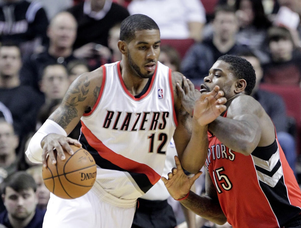 Portland Trail Blazers forward LaMarcus Aldridge, left, drives on Toronto Raptors forward Amir Johnson during the first half of an NBA basketball game in Portland, Ore., Saturday, Feb. 1, 2014.