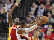 Portland's LaMarcus Aldridge pulls down a rebound in front of Houston's Terrence Jones, left, during the first half Thursday.