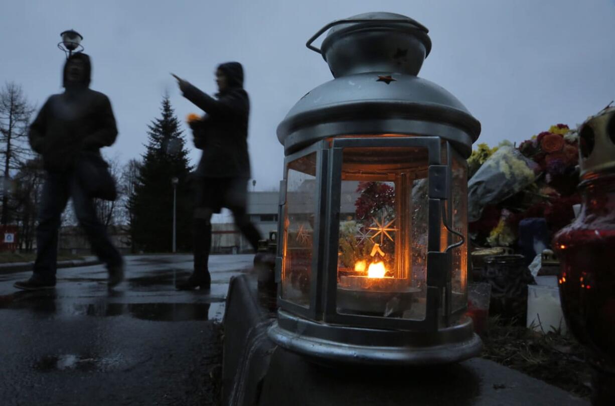 People bring flowers and toys and light candles at a facility where identification of plane crash victims is being held, in St. Petersburg, Russia, on Tuesday. A homemade explosive device brought down a Russian passenger plane over Egypt last month, the head of Russia&#039;s FSB security service said Tuesday, telling President Vladimir Putin it&#039;s now clear the bombing that killed 224 people was a &quot;terrorist&quot; act.