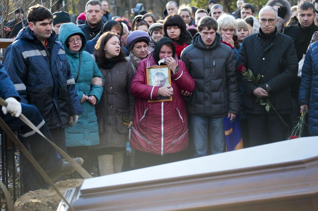 Maria, center, the mother of Alexei Alekseyev, one of the plane crash victims, reacts, during his funeral at Bogoslovskoye cemetery in St. Petersburg, Russia, on Thursday. The first victims of Saturday?s plane crash over Egypt were laid to rest on Thursday following funeral services in St. Petersburg and Veliky Novgorod, Russia. Russia&#039;s Airbus 321-200 broke up over the Sinai Peninsula en route from the resort town of Sharm el-Sheikh to St. Petersburg, killing all 224 on board.