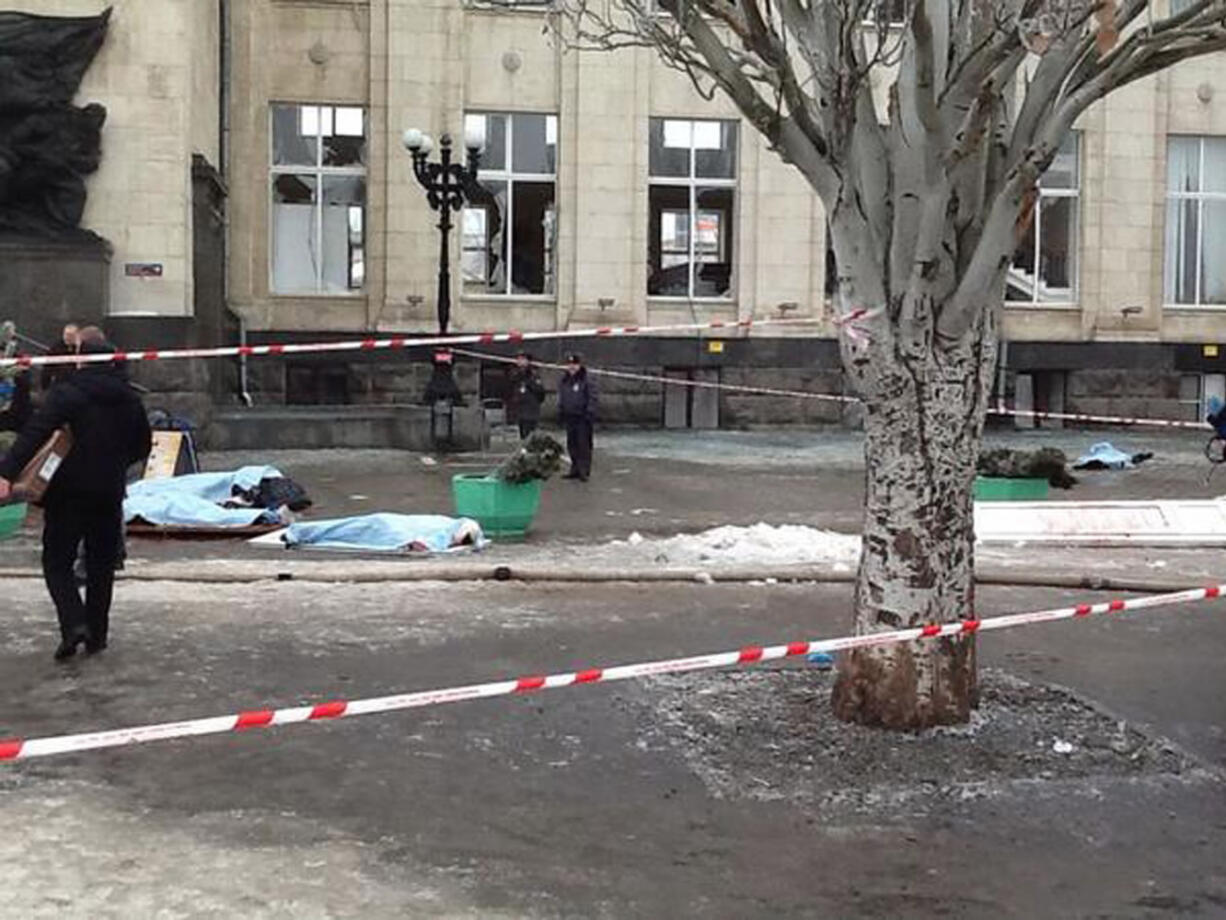 In this photo taken on a cell phone,  made available by Volgograd Mayor's Office, bodies lie at an entrance to Volgograd railway station, Sunday.