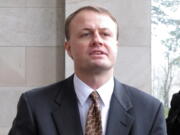 Activist Tim Eyman speaks to the media in front of the Capitol in Olympia.