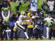 Seattle Seahawks running back Marshawn Lynch (24) runs past New Orleans Saints cornerback Keenan Lewis (28) to score on a 31-yard touchdown during the fourth quarter Saturday. (AP Photo/Ted S.