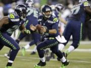 Seattle Seahawks quarterback Russell Wilson drops back against the New Orleans Saints, Monday, Dec.