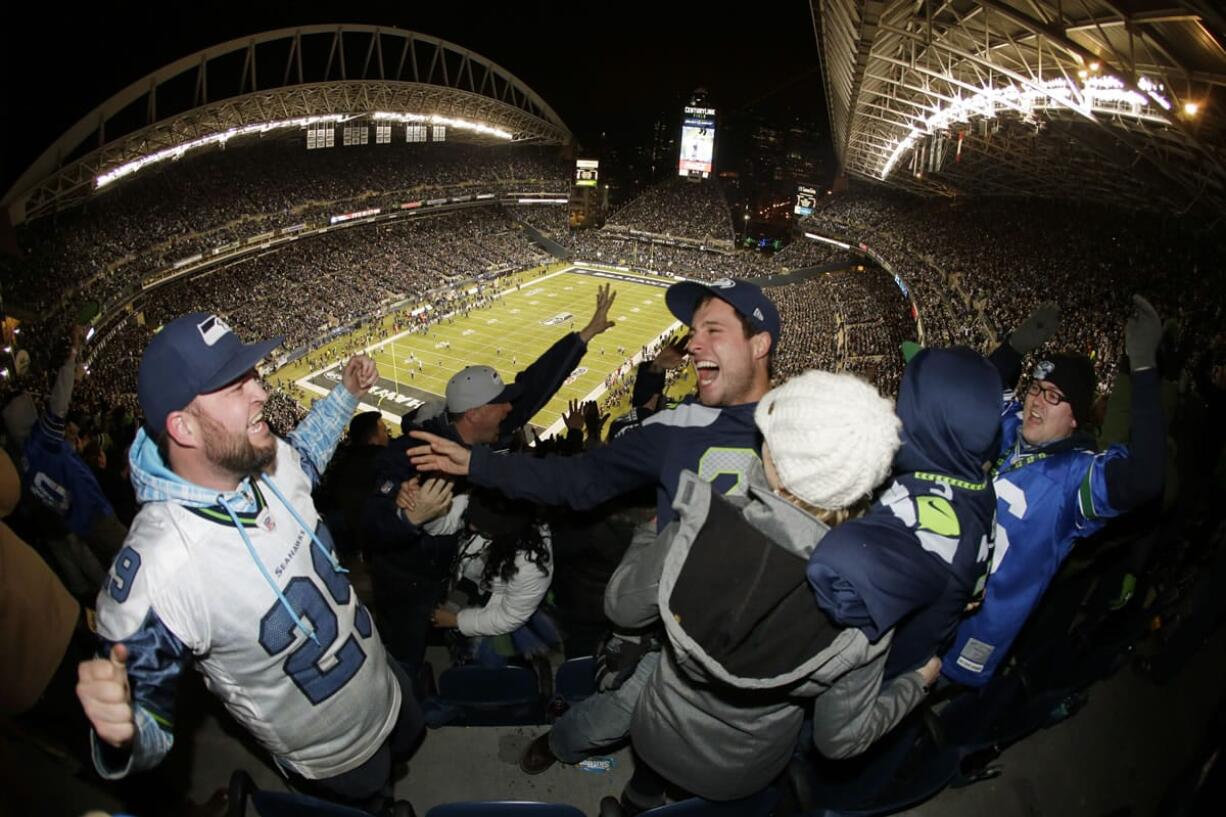 Seattle fans celebrate a fumble return for a touchdown by Michael Bennett during Monday's game against New Orleans.