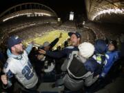 Seattle fans celebrate a fumble return for a touchdown by Michael Bennett during Monday's game against New Orleans.