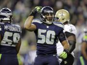 Seattle Seahawks K.J. Wright (50) gestures after a play against the New Orleans Saints in the second half of an NFL football game, Monday, Dec. 2, 2013, in Seattle.