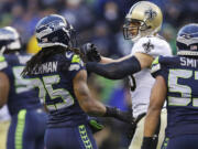 New Orleans tight end Jimmy Graham gets in a scuffle with Seattle's Richard Sherman (25) during a playoff game in 2014.