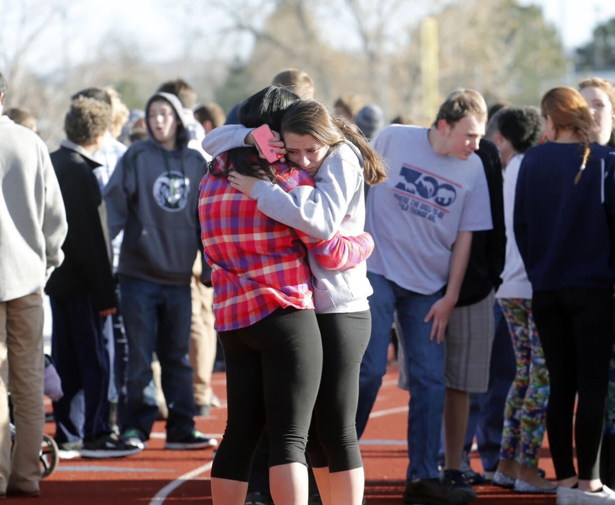 Students comfort each other at Arapahoe High School in Centennial, Colo., on Friday at a Colorado high school Friday after a shooter apparently killed himself, authorities said.