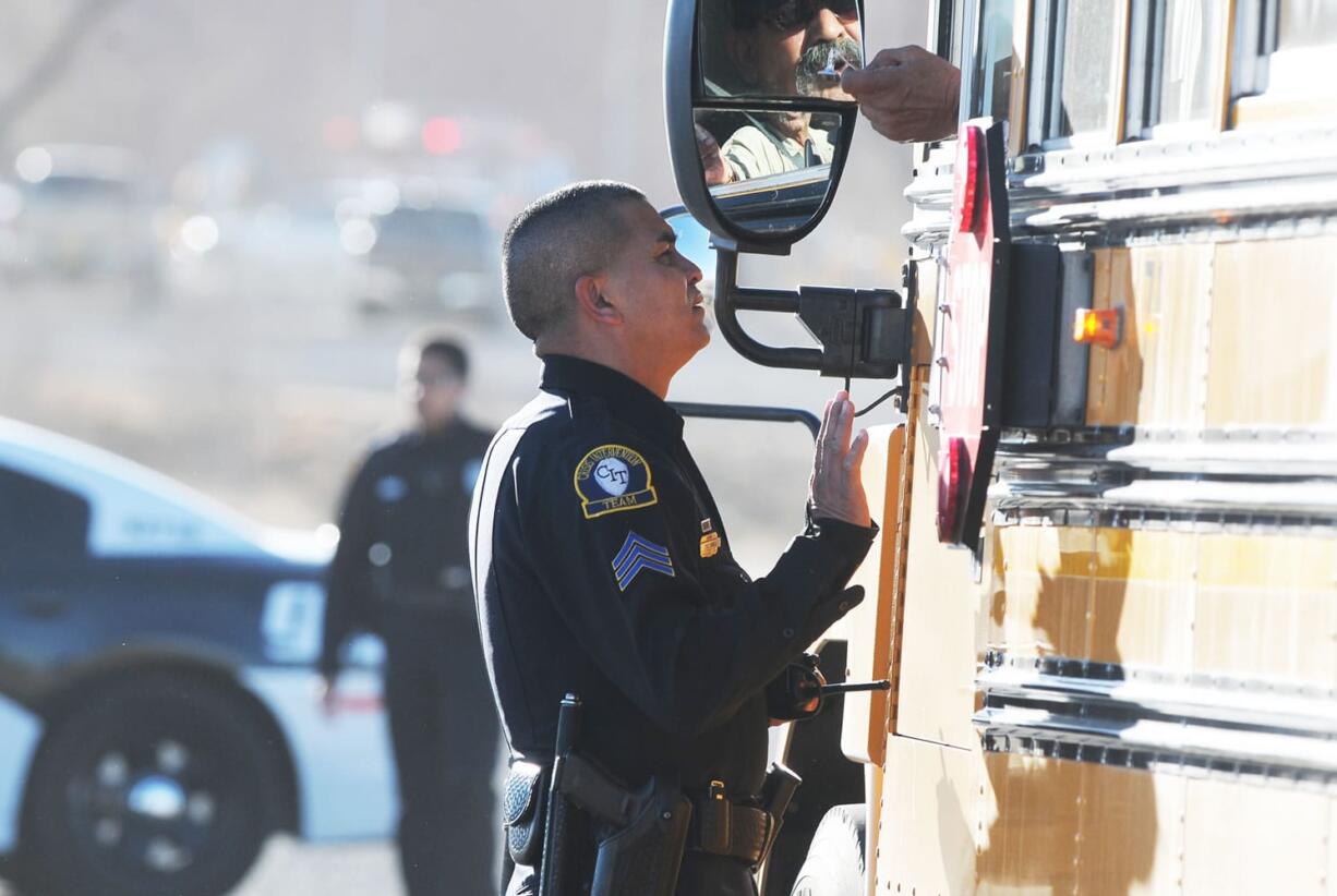 Law enforcement personnel set up a perimeter following a shooting at Berrendo Middle School on Tuesda in Roswell, N.M. Roswell police said the suspected shooter was arrested at the school, but authorities have not said if there were any injuries. The school has been placed on lockdown.