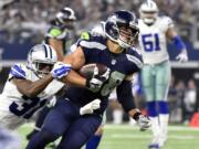 Dallas Cowboys' Byron Jones (31) tackles Seattle Seahawks' Jimmy Graham (88) after Graham caught a pass in the second half of an NFL football game Sunday, Nov. 1, 2015, in Arlington, Texas.