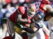 San Francisco 49ers running back Frank Gore (21) is tackled by Seattle Seahawks' middle linebacker Bobby Wagner (54) in the first half Sunday.