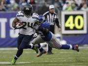 Seattle Seahawks running back Marshawn Lynch (24) avoid the tackle of New York Giants middle linebacker Jon Beason (52) during the first half Sunday.