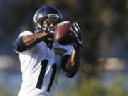 Seattle Seahawks wide receiver Percy Harvin makes a catch as he takes part in an NFL football practice, Tuesday, Oct. 22, 2013, in Renton, Wash. It was Harvin's first full team practice since he injured his hip during the off-season. (AP Photo/Ted S.