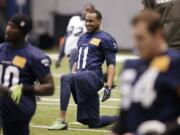 Seattle Seahawks' Percy Harvin (11) smiles as he stretches during practice last week.