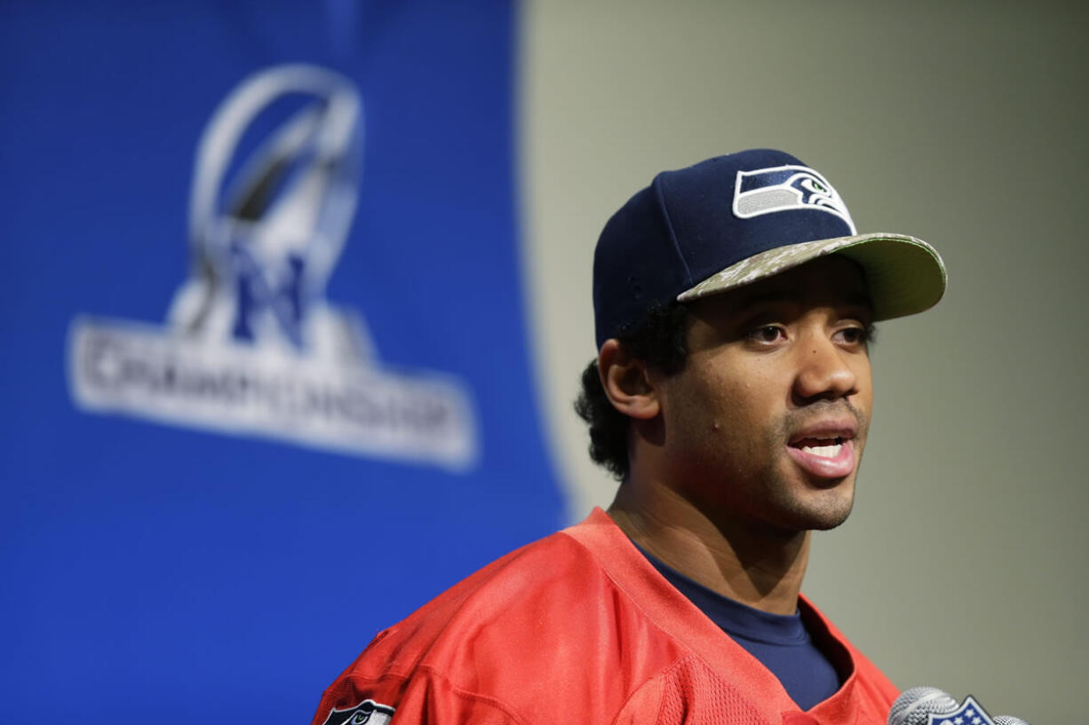 Seattle Seahawks quarterback Russell Wilson talks to reporters Wednesday in Renton.