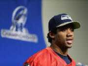 Seattle Seahawks quarterback Russell Wilson talks to reporters Wednesday in Renton.