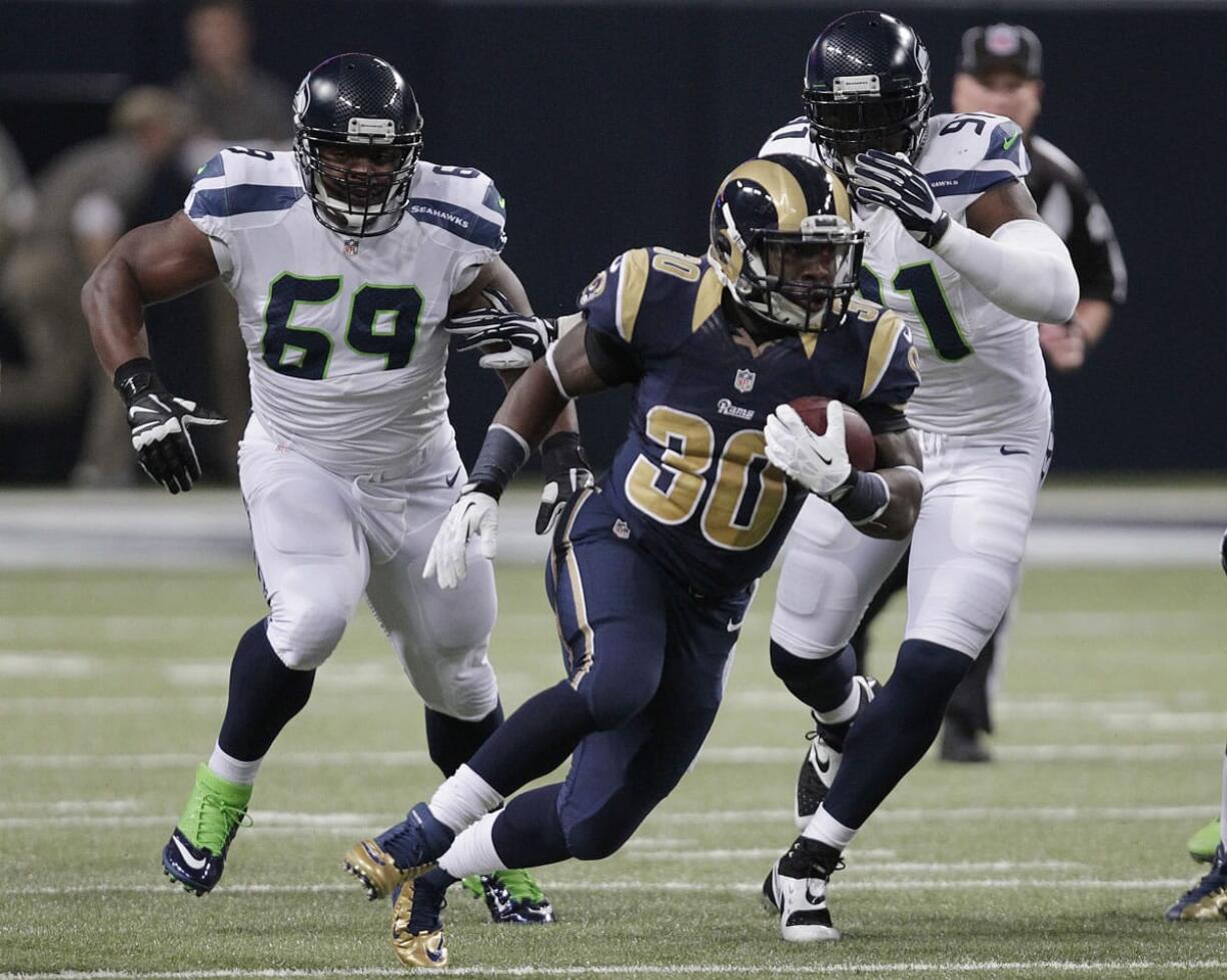 St. Louis Rams running back Zac Stacy (30) rushes against Seattle Seahawks defense during the first half on Monday, Oct. 28, 2013, in St. Louis.