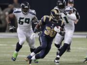 St. Louis Rams running back Zac Stacy (30) rushes against Seattle Seahawks defense during the first half on Monday, Oct. 28, 2013, in St. Louis.