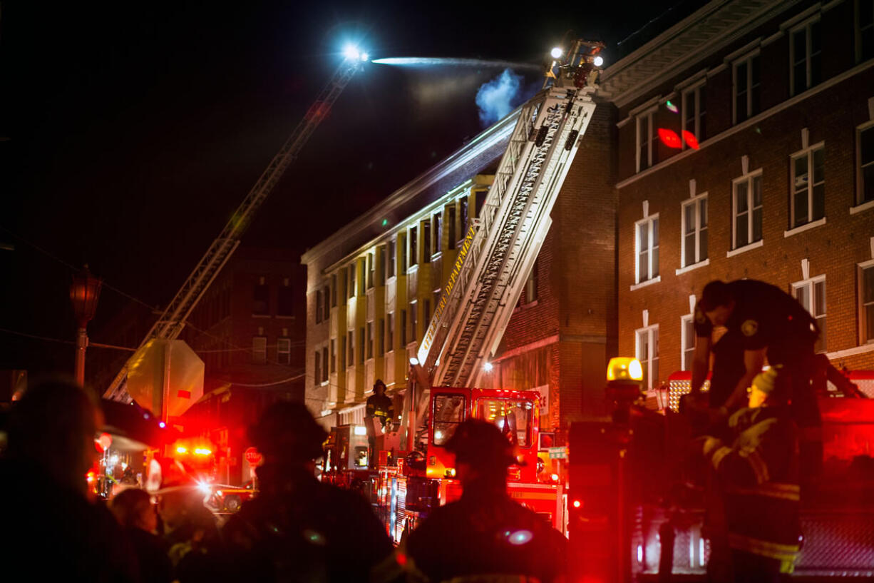 An estimated 90 firefighters battled a blaze that began around 4 p.m. Tuesday in Seattle. The fire forced more than 20 people living nearby to evacuate, fire officials said Tuesday.