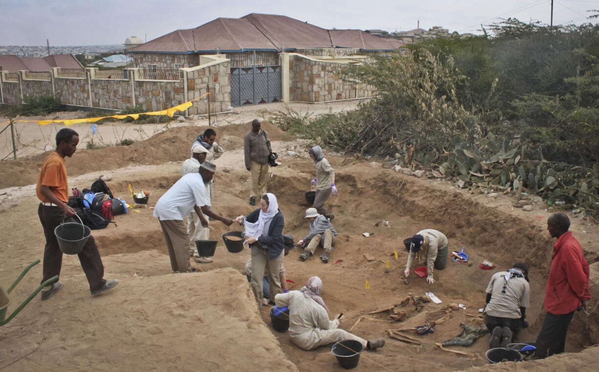 Members of the Peruvian Forensic Anthropology Team work on Feb. 18 to uncover bodies buried in a mass grave in Hargeisa, Somaliland, a breakaway region of Somalia.