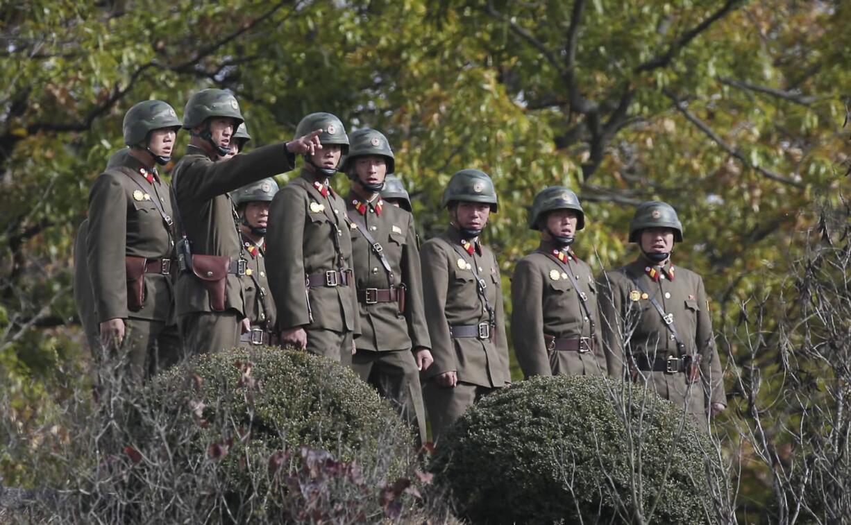 North Korean army solider look southern side as U.S. Defense Secretary Ash Carter visits at the border village of Panmunjom, which has separated the two Koreas since the Korean War, in Paju, South Korea, Sunday, Nov. 1, 2015. Carter called on North Korea to shrink and eventually eliminate its nuclear weapons program, while acknowledging during a visit Sunday to the Demilitarized Zone dividing the two Koreas that prospects for reconciling with the defiant North are dim.