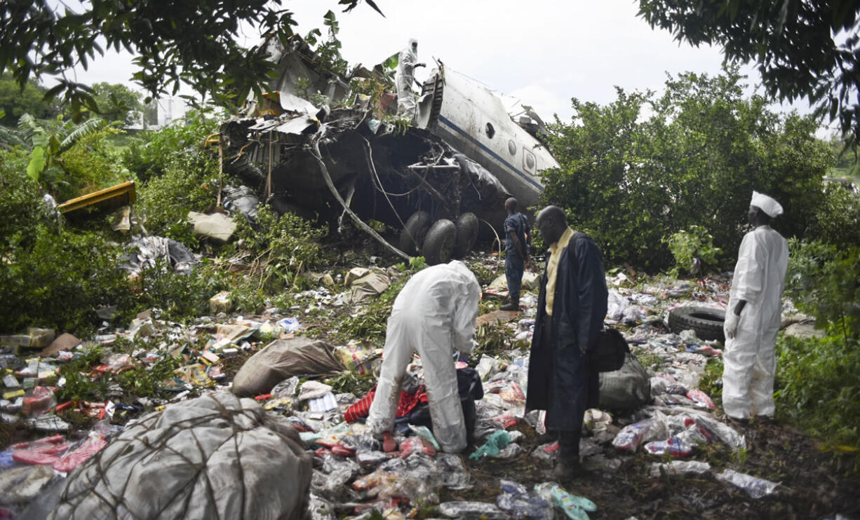 Responders pick through the wreckage of a cargo plane which crashed in the capital Juba, South Sudan, on Wednesday. The cargo plane was taking off from the South Sudanese capital of Juba when it crashed along the banks of the Nile River, killing dozens according to witnesses and the government.