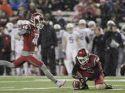 Washington State place kicker Erik Powell (46) kicks a field goal as wide receiver Kaleb Fossum (38) holds during the first half of an NCAA college football game against Stanford, Saturday, Oct. 31, 2015, in Pullman, Wash.