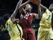 Stanford's Anthony Brown, center, drives between Oregon's Elgin Cook, left, and Dominic Artis, right, during the first half Sunday.