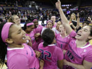 Washington's Talia Walton, left, and Kelsey Plum, right, celebrate with teammates after they upset No. 3 Stanford on Sunday.