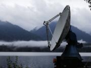 A truck-mounted radar instrument called the Doppler On Wheels scans cloudy skies Friday on the banks of Lake Quinault near Amanda Park. Led by NASA and hosted by the University of Washington, a team of meteorologists and scientists is fanning out across one of the wettest places in the country in November to measure raindrops and snowdrops and attempt to validate, on the ground, how well global satellites measure precipitation from space. (Ted S.